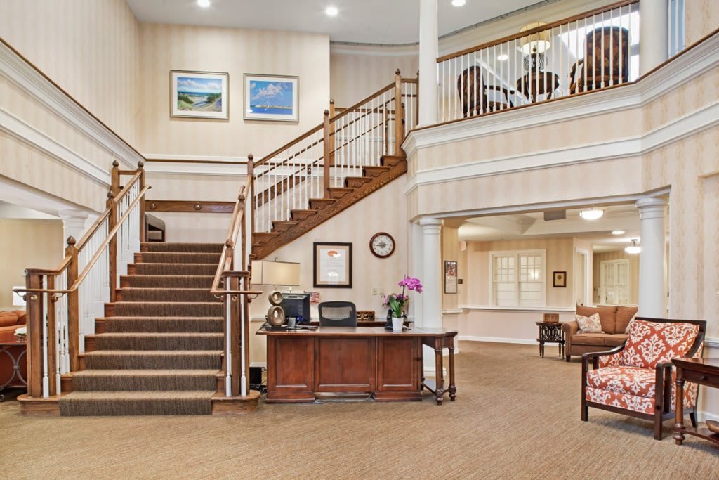 Elegant lobby area with a reception desk and staircase.