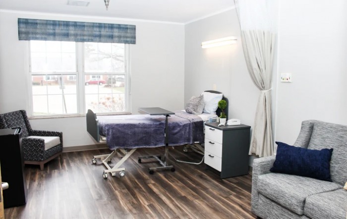 A modern hospital room with a medical bed and minimalist decor.