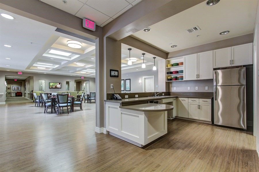 A modern kitchen and dining area with natural lighting and wood flooring.