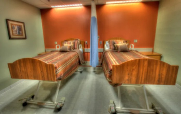 A hospital room with two patient beds prepared for use.