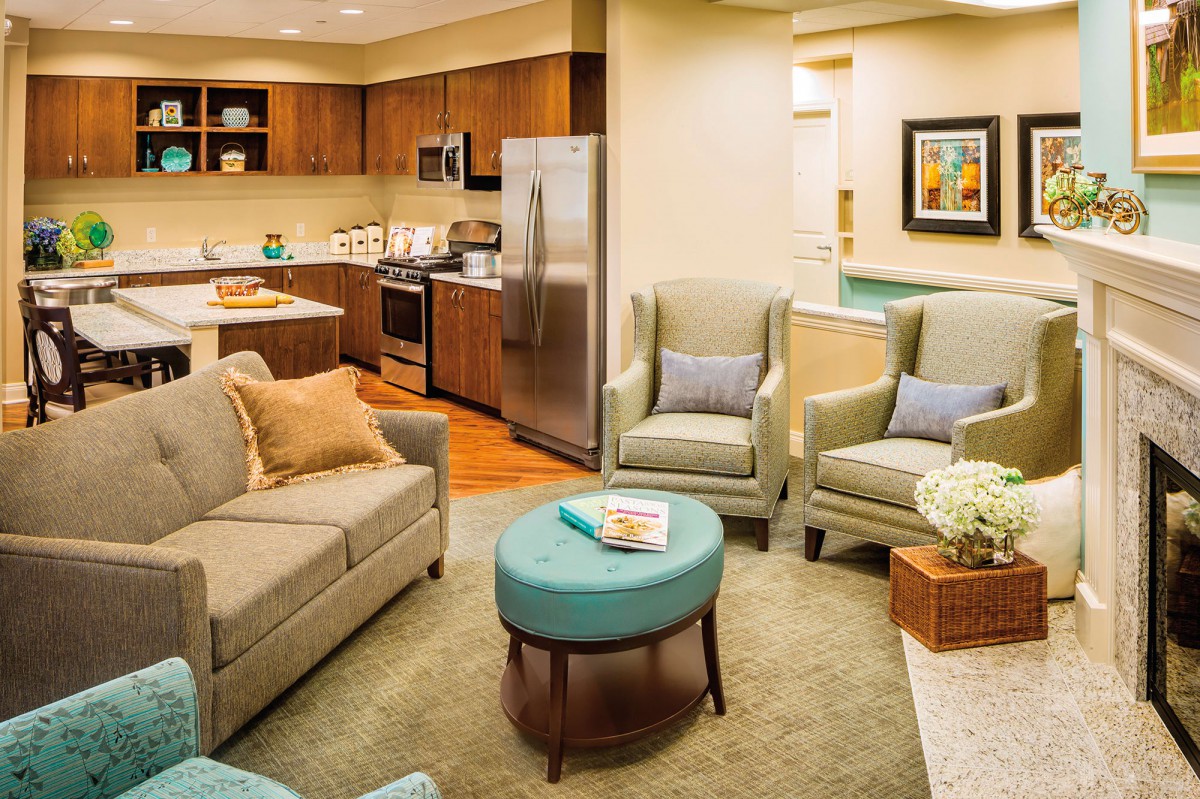 A modern living room with comfortable seating and an adjacent kitchen.