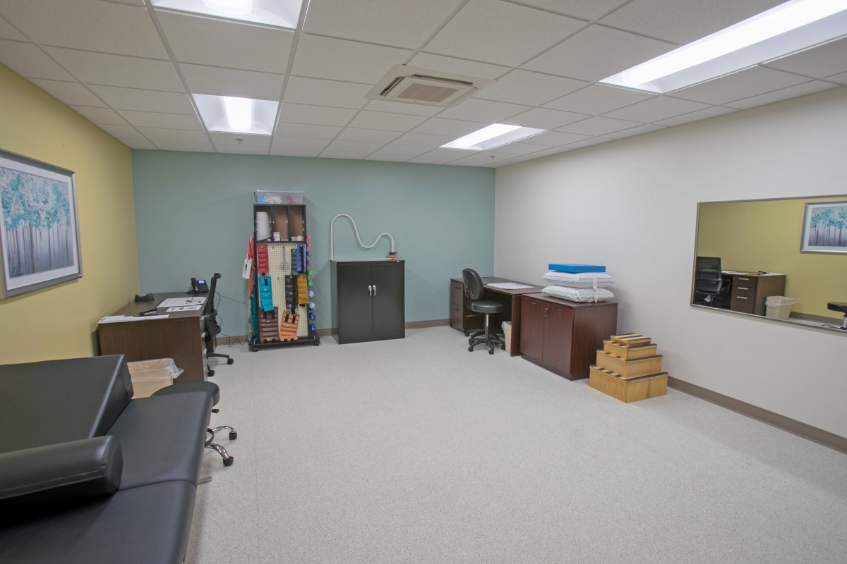 An empty office space with desks and shelves.