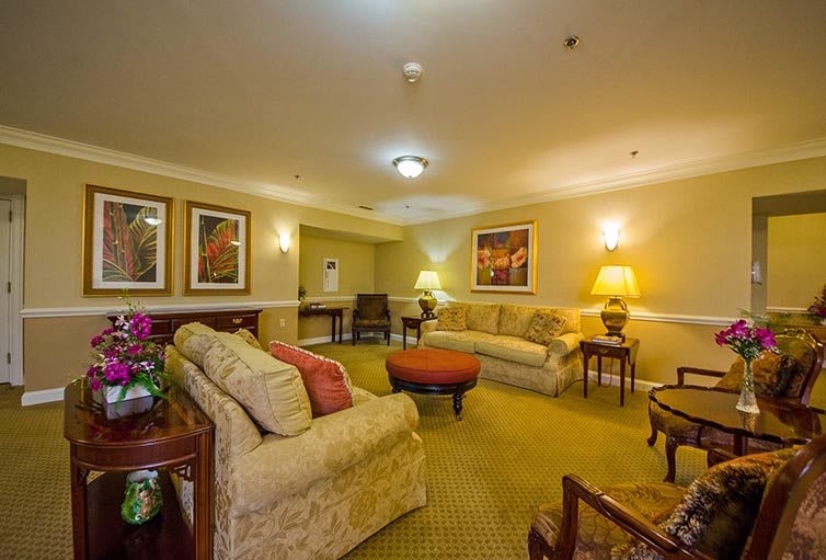 A cozy living room with comfortable sofas and warm lighting.