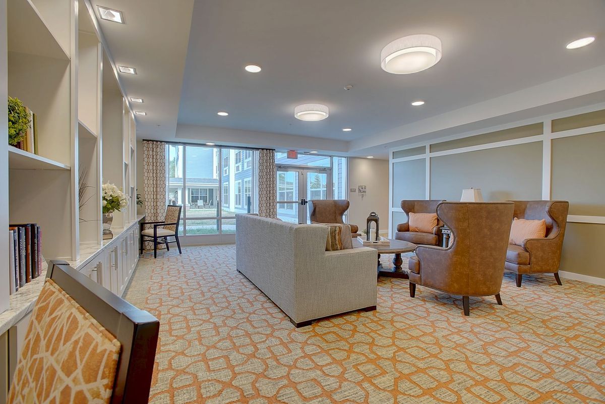 A modern living room with comfortable seating and large windows.