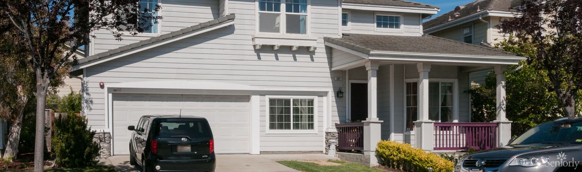 A suburban residential house with a garage and driveway.