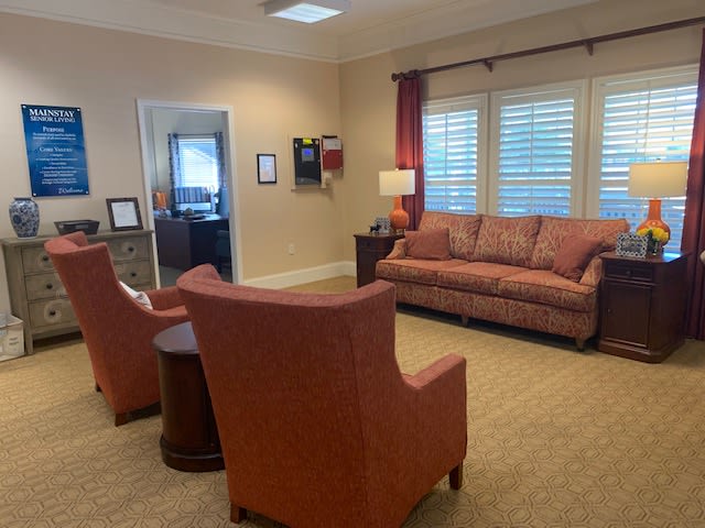 A cozy living room with comfortable seating and warm lighting.