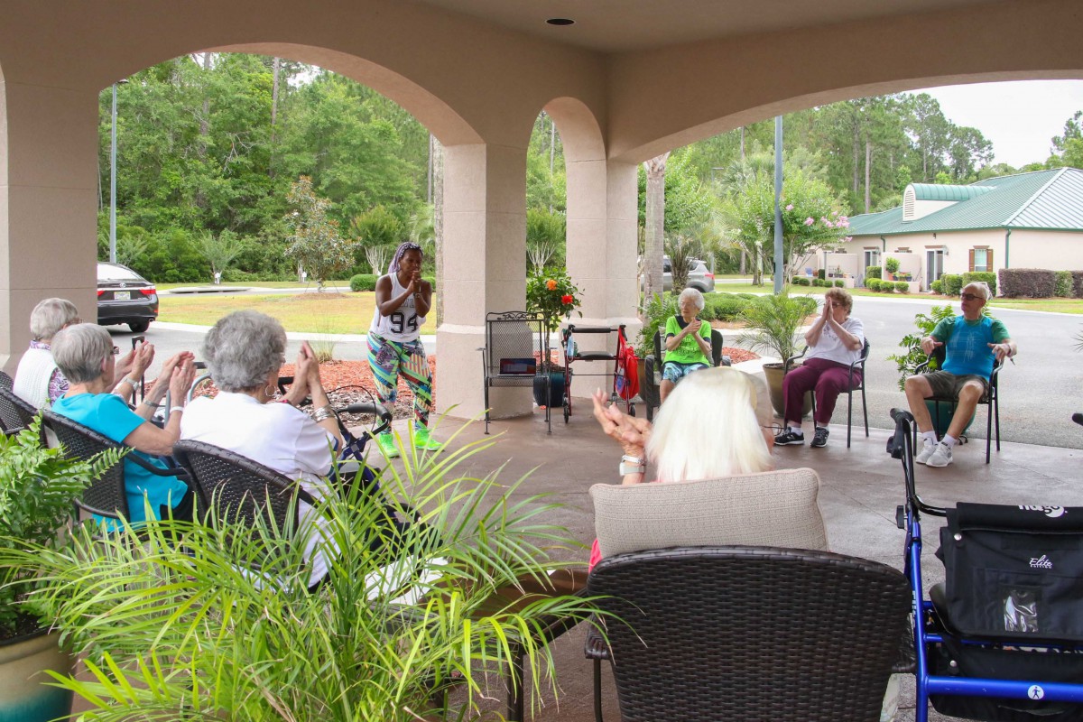 A group of people enjoying an outdoor gathering under a pavilion.