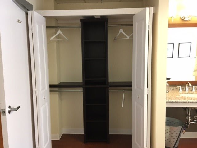 An empty closet with shelves and hangers.