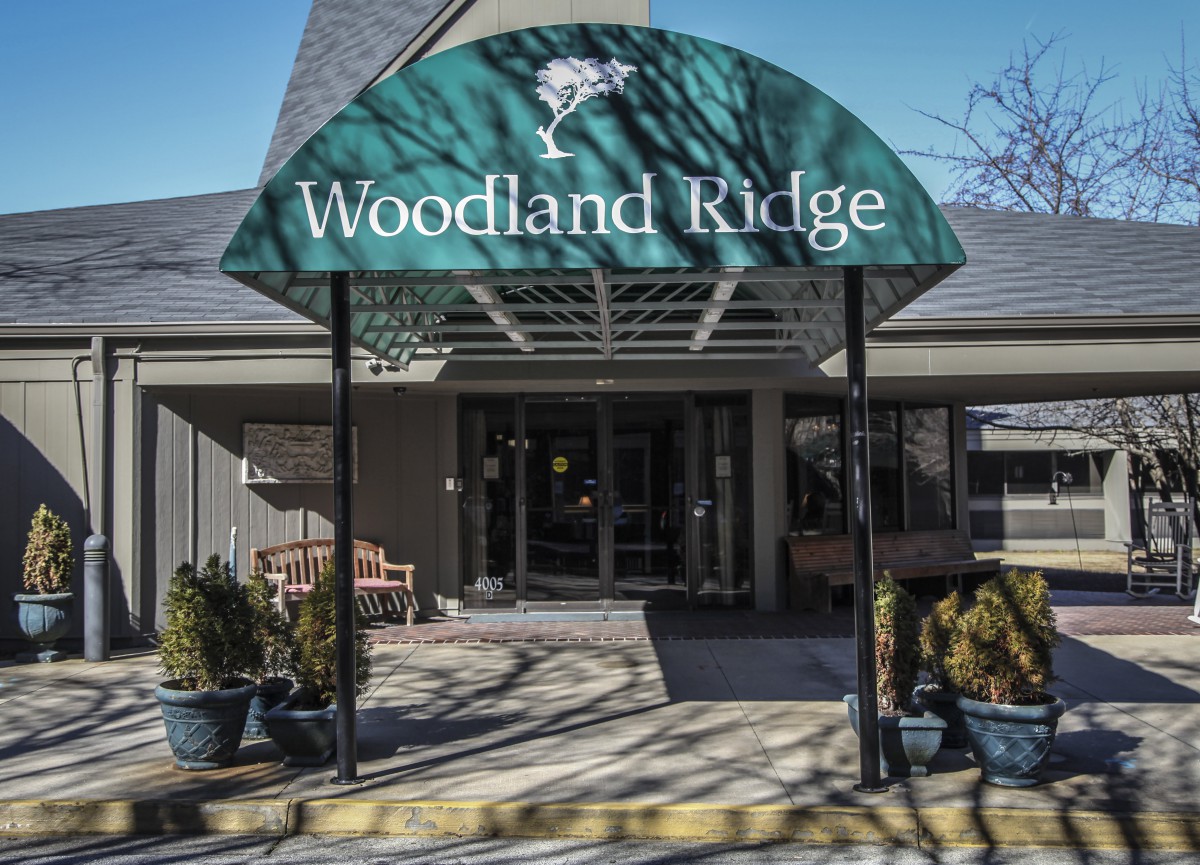 Entrance to Woodland Ridge with a green awning.