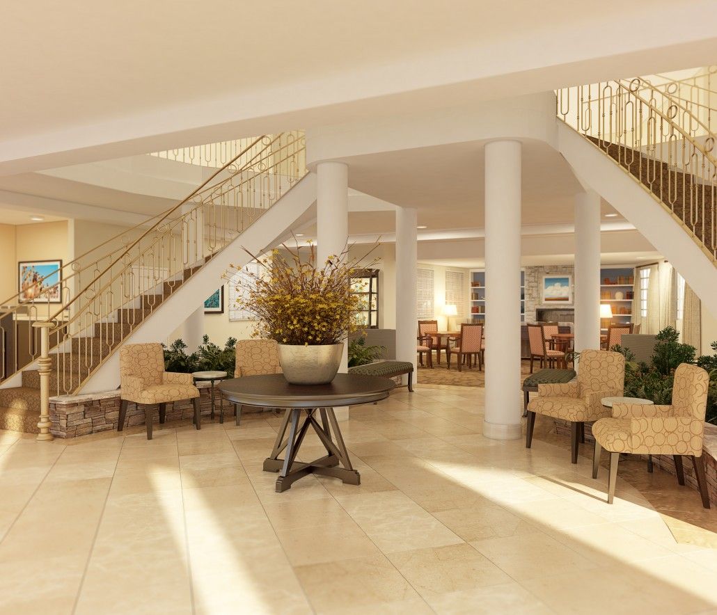 A spacious and elegantly designed lobby area featuring modern furniture and a staircase.