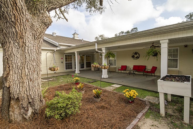 A cozy backyard patio with outdoor seating and a well-maintained garden.