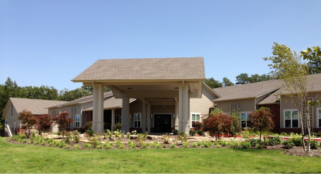 A modern building with a prominent entrance and landscaped surroundings.