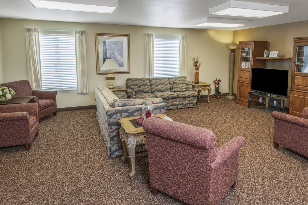 A neatly arranged living room with patterned couches, a coffee table, and decorative items.