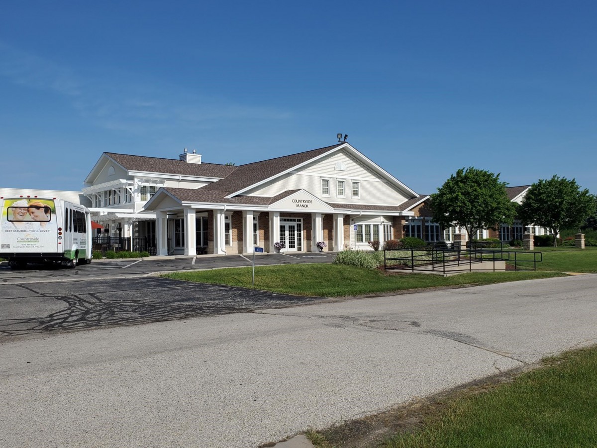 A suburban residential building with a well-maintained exterior and driveway on a clear day.