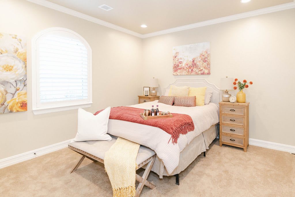 A cozy, minimalist bedroom with neutral colors and elegant decor.
