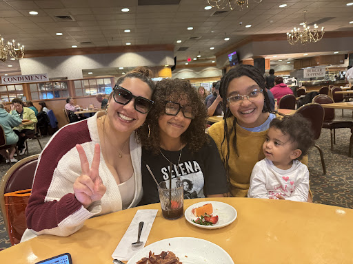 A joyful family gathering at a restaurant, sharing smiles and delicious food.