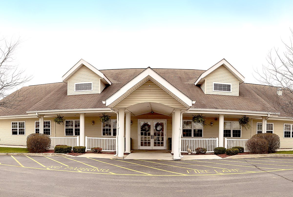 A symmetrical building with a prominent entrance and pitched roof.