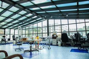 A modern office workspace featuring large windows and ample natural light.