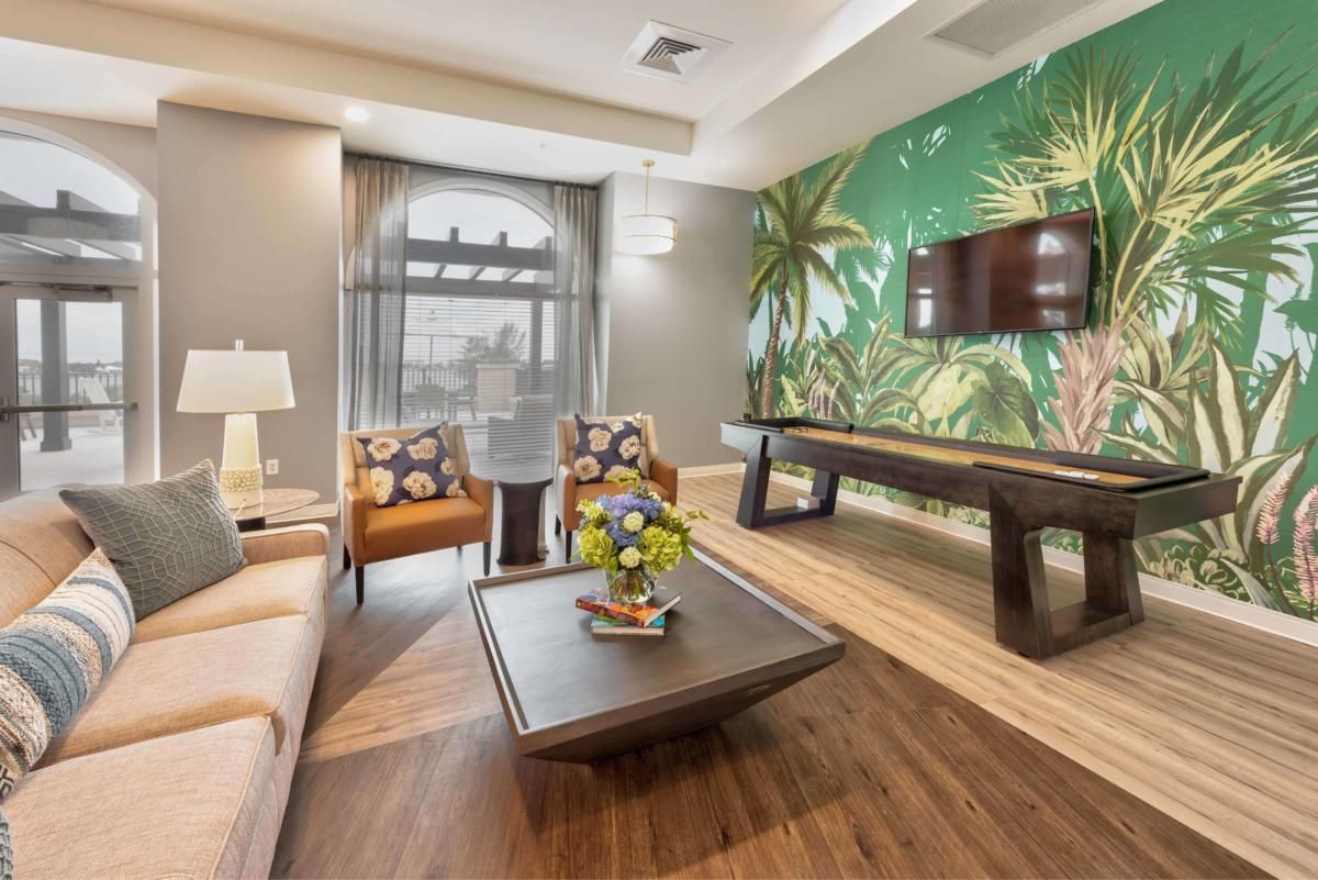 A modern living room with a vibrant wall mural and stylish furniture.