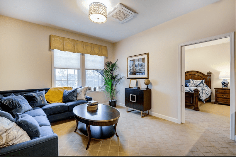 A modern living room with a comfortable sofa, coffee table, and elegant decor.
