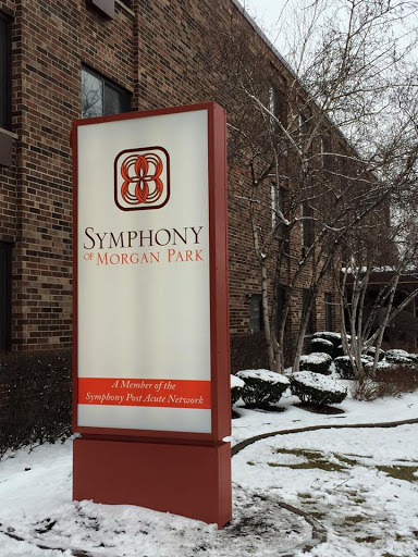 A sign for Symphony Property Park surrounded by snow.