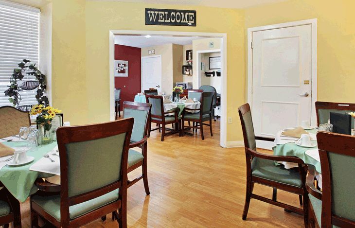 A cozy dining area with neatly arranged tables and chairs, featuring a welcoming atmosphere.