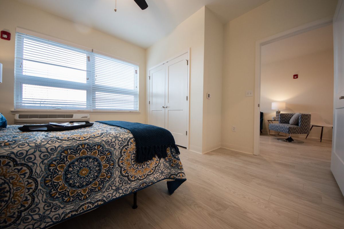 A cozy bedroom interior with stylish decor and natural lighting.