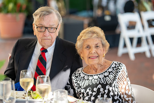 A happy elderly couple enjoying their time together at a festive dinner.