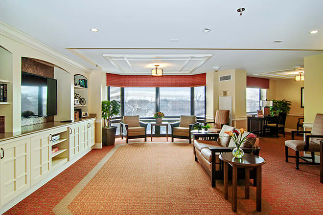 A well-lit lobby area with comfortable seating and large windows.