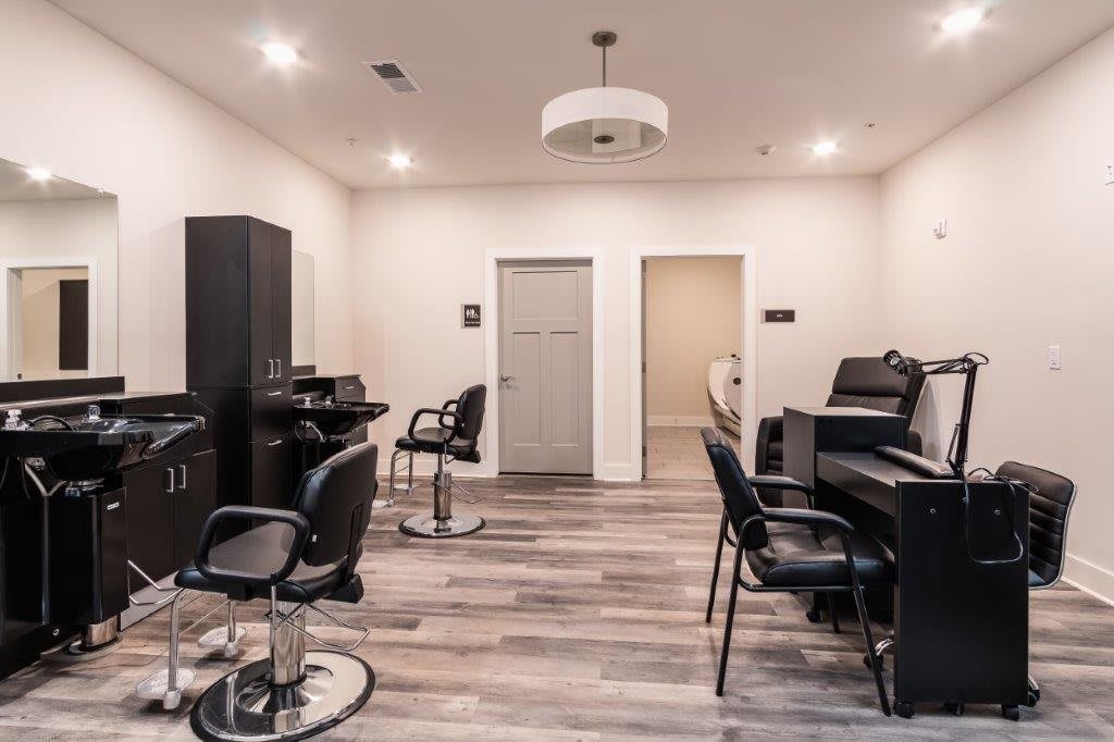 Modern hair salon interior with styling chairs and stations.