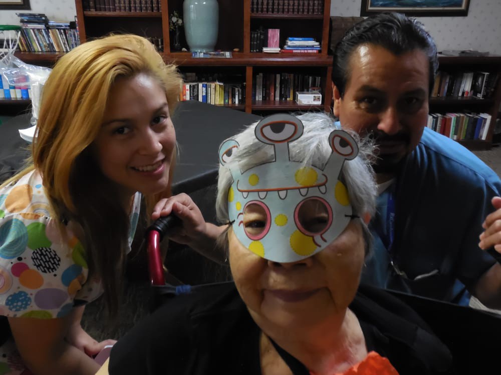 A joyful family moment with a person wearing a colorful mask.