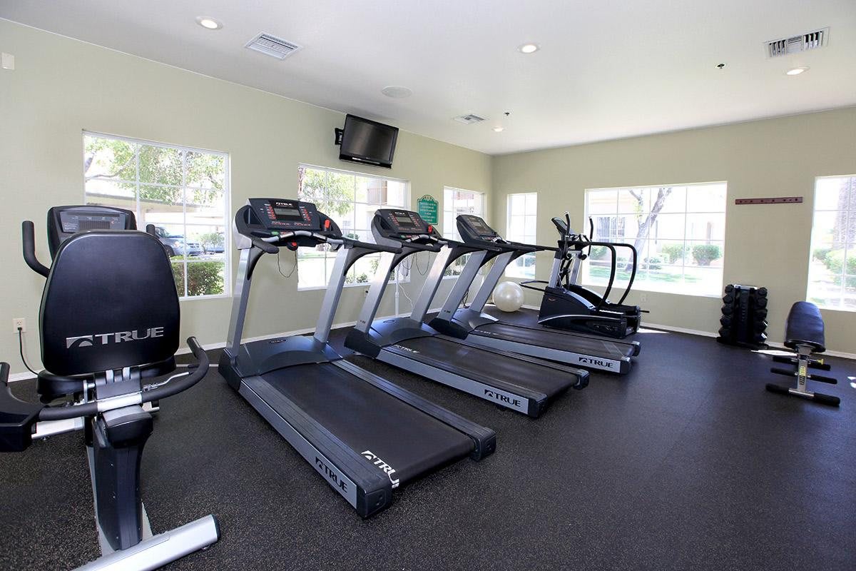 A gym with several treadmills and exercise equipment.