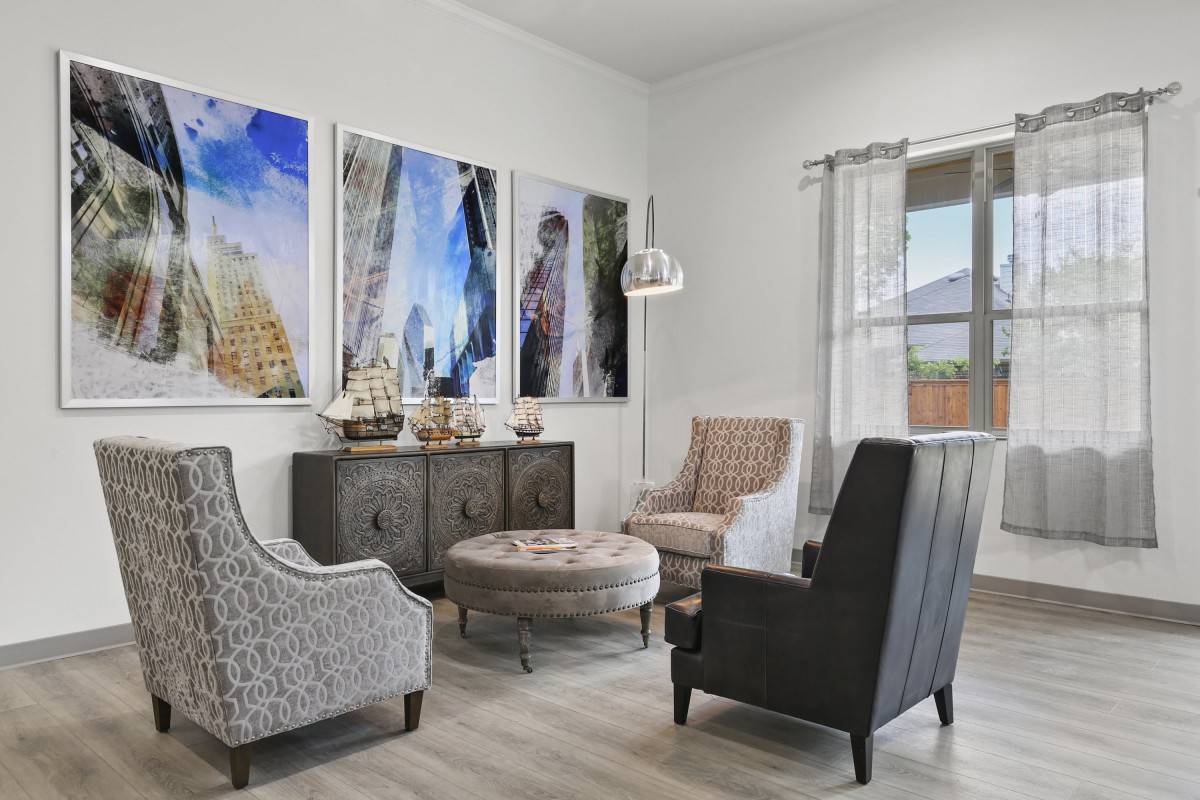 A cozy living room with stylish furniture and modern artwork on the walls.