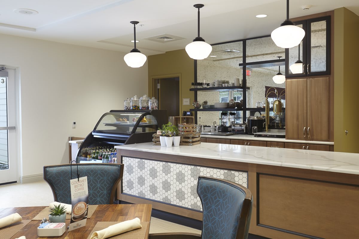 A modern cafe interior with seating and a display counter.