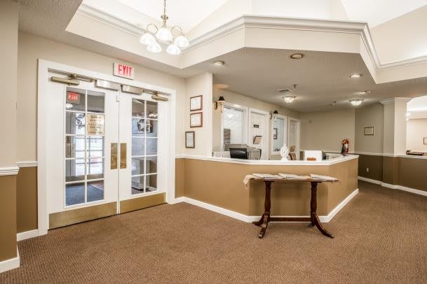 A welcoming office reception area with a desk and large doors.