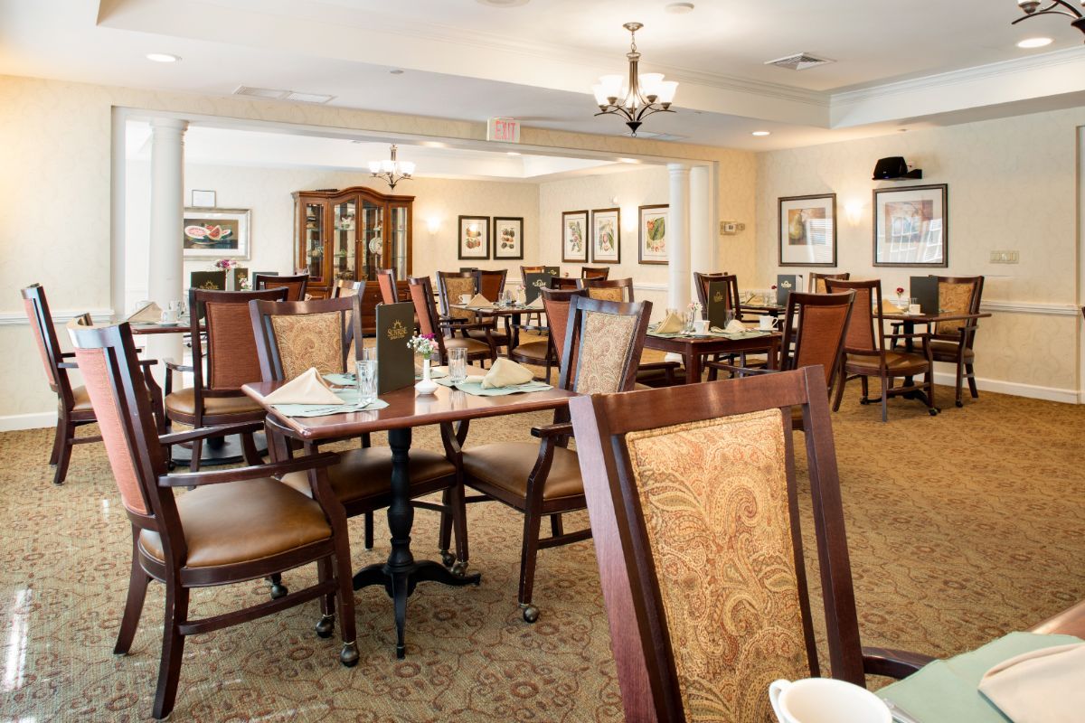 An elegant dining room with neatly arranged tables and chairs, adorned with classic decor.