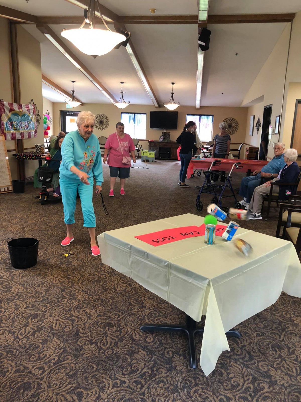 Elderly individuals enjoying a fun indoor game at a community center.