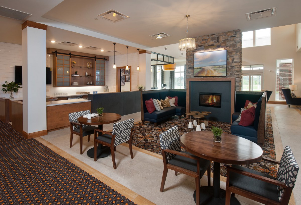 A modern living room with a cozy seating area and fireplace.
