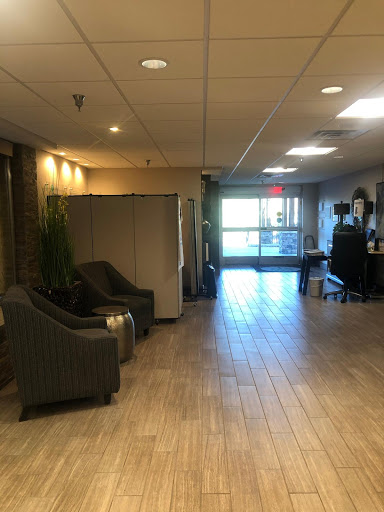 A spacious and well-lit lobby featuring comfortable seating and access to the outdoors.