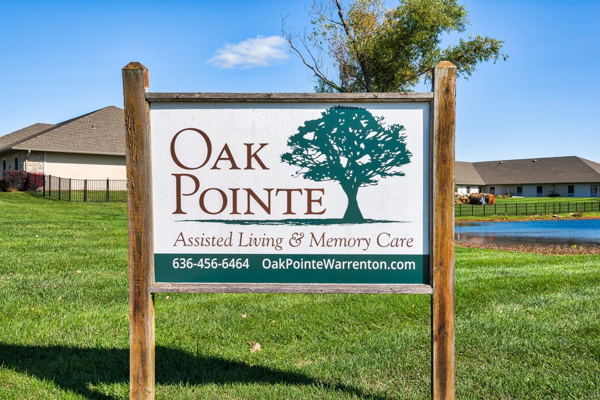 A sign for Oak Pointe Assisted Living & Memory Care facility.