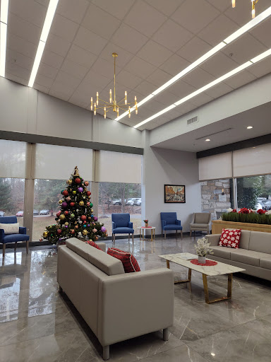 A modern lobby decorated for the holidays, featuring a beautifully adorned Christmas tree.