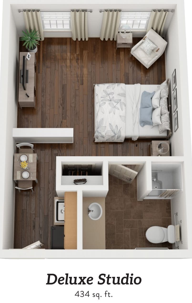 A compact apartment floor plan featuring a bedroom, living area, kitchenette, and bathroom.