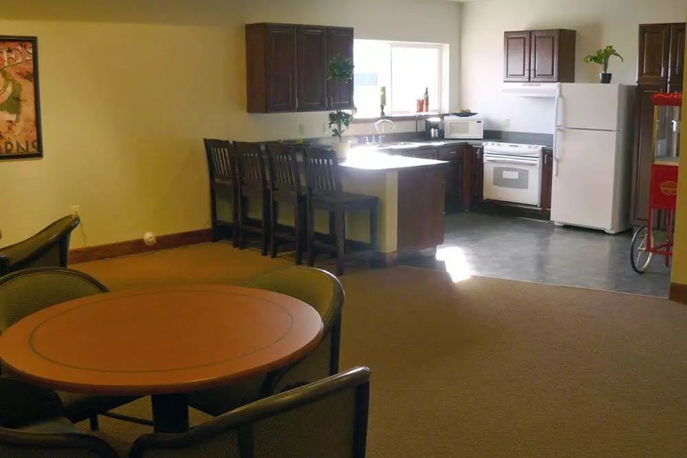 A cozy kitchen and dining area with a table, chairs, and modern appliances.