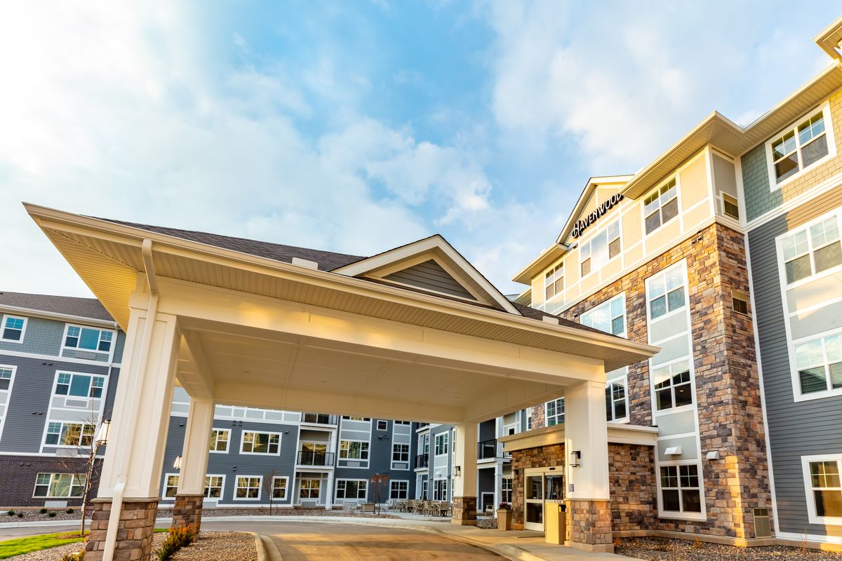 A modern residential building with a covered entrance.