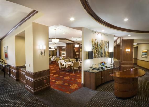 An elegant hotel lobby and dining area with modern furnishings and warm lighting.
