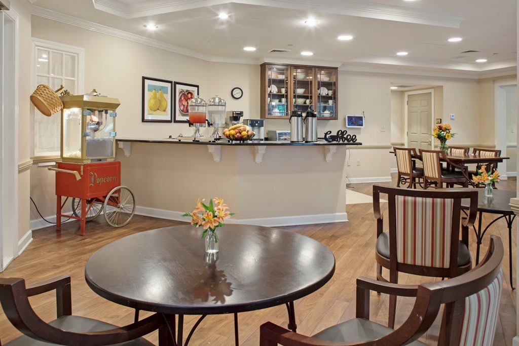 Cozy indoor cafe with a seating area and a counter.