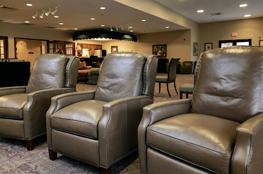A row of comfortable leather recliners in a cozy lounge setting.