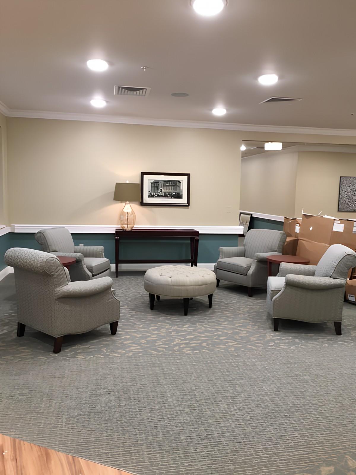 A cozy lobby area with armchairs arranged around a central table.
