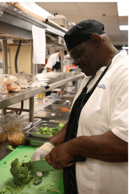 A chef in a commercial kitchen preparing food.