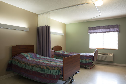 A hospital room featuring two beds, designed for patient care.